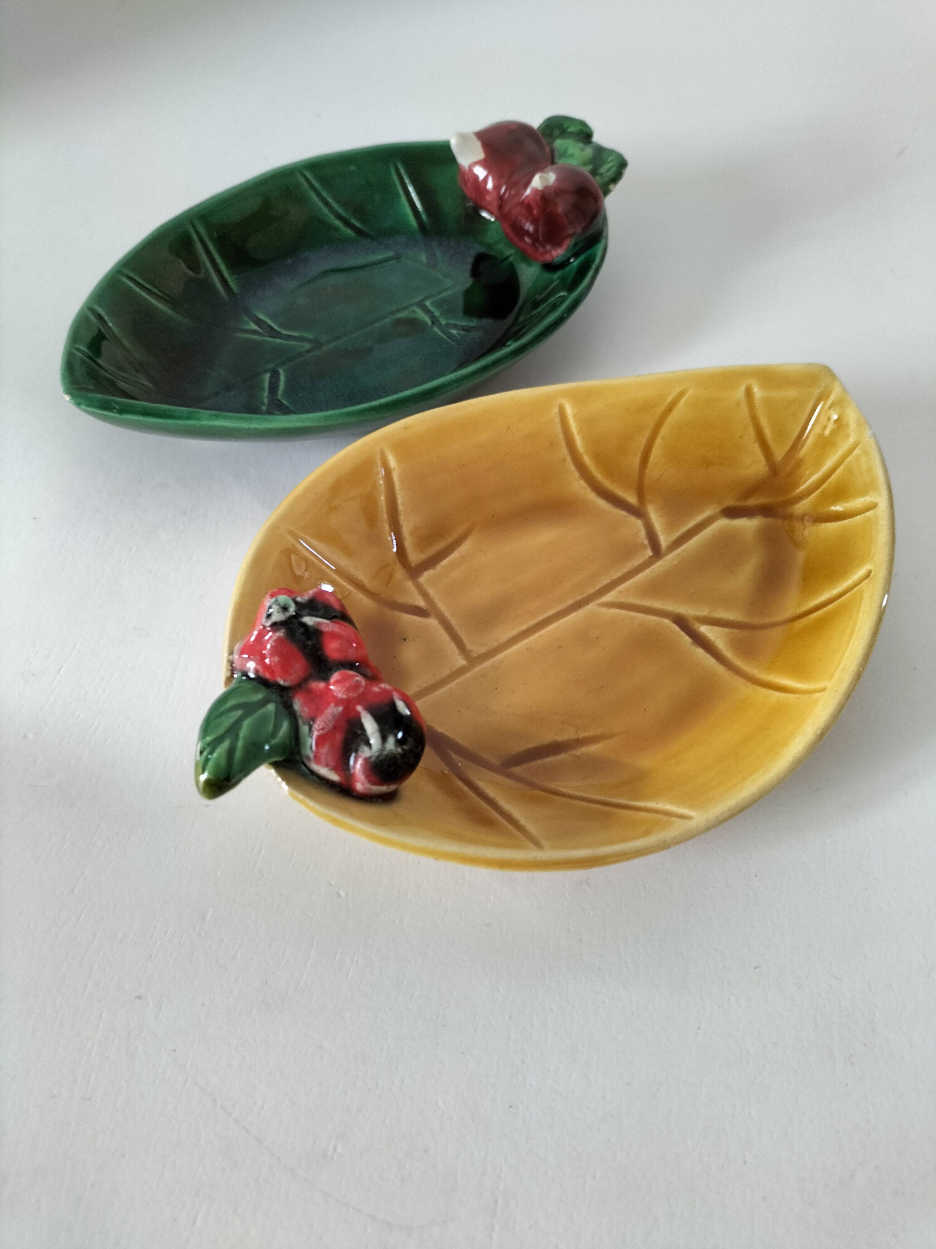 Two relief bowls with leaf designs, radishes, and tomatoes.