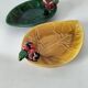Two relief bowls with leaf designs, radishes, and tomatoes.