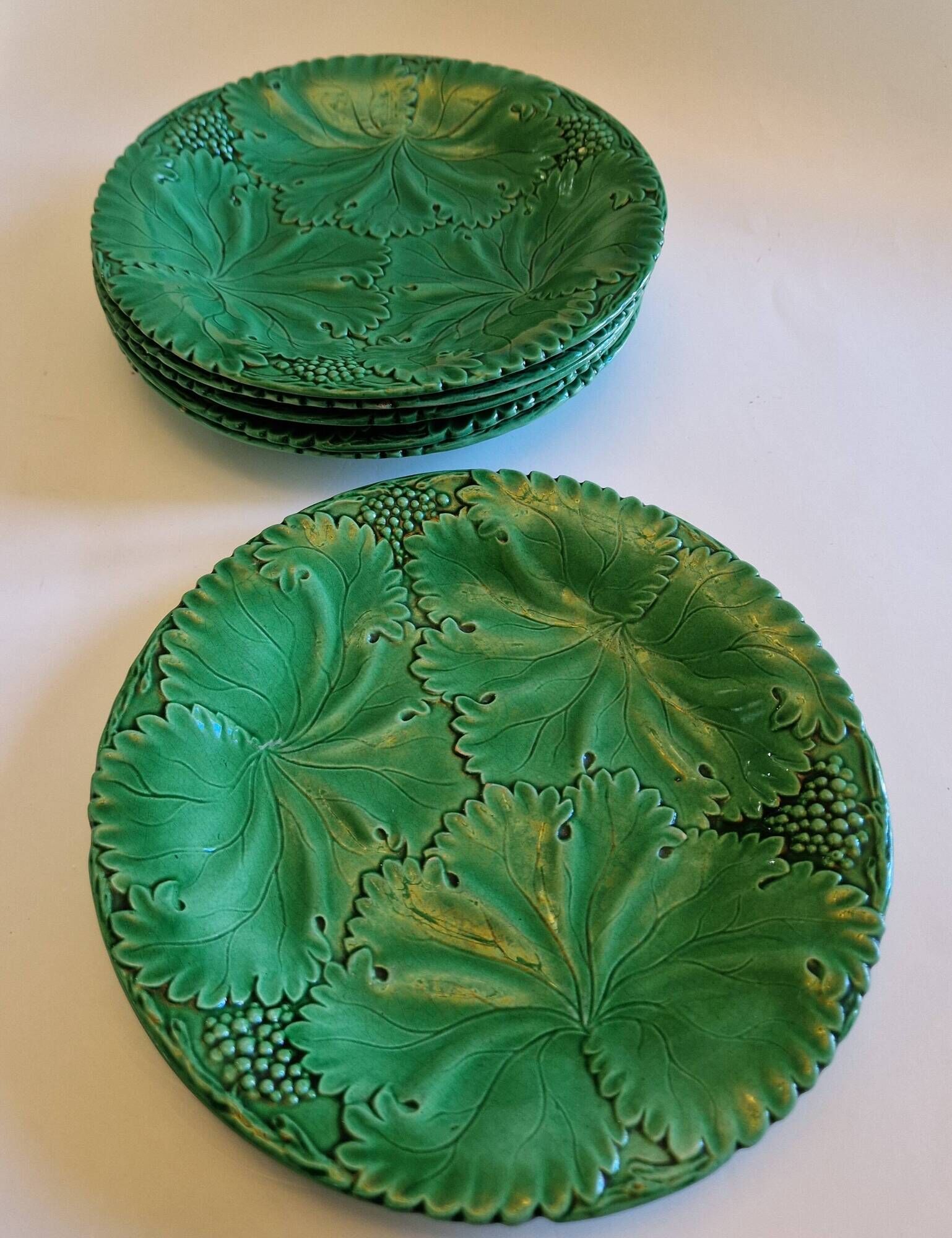8 green barbotine plates from the early 20th century.