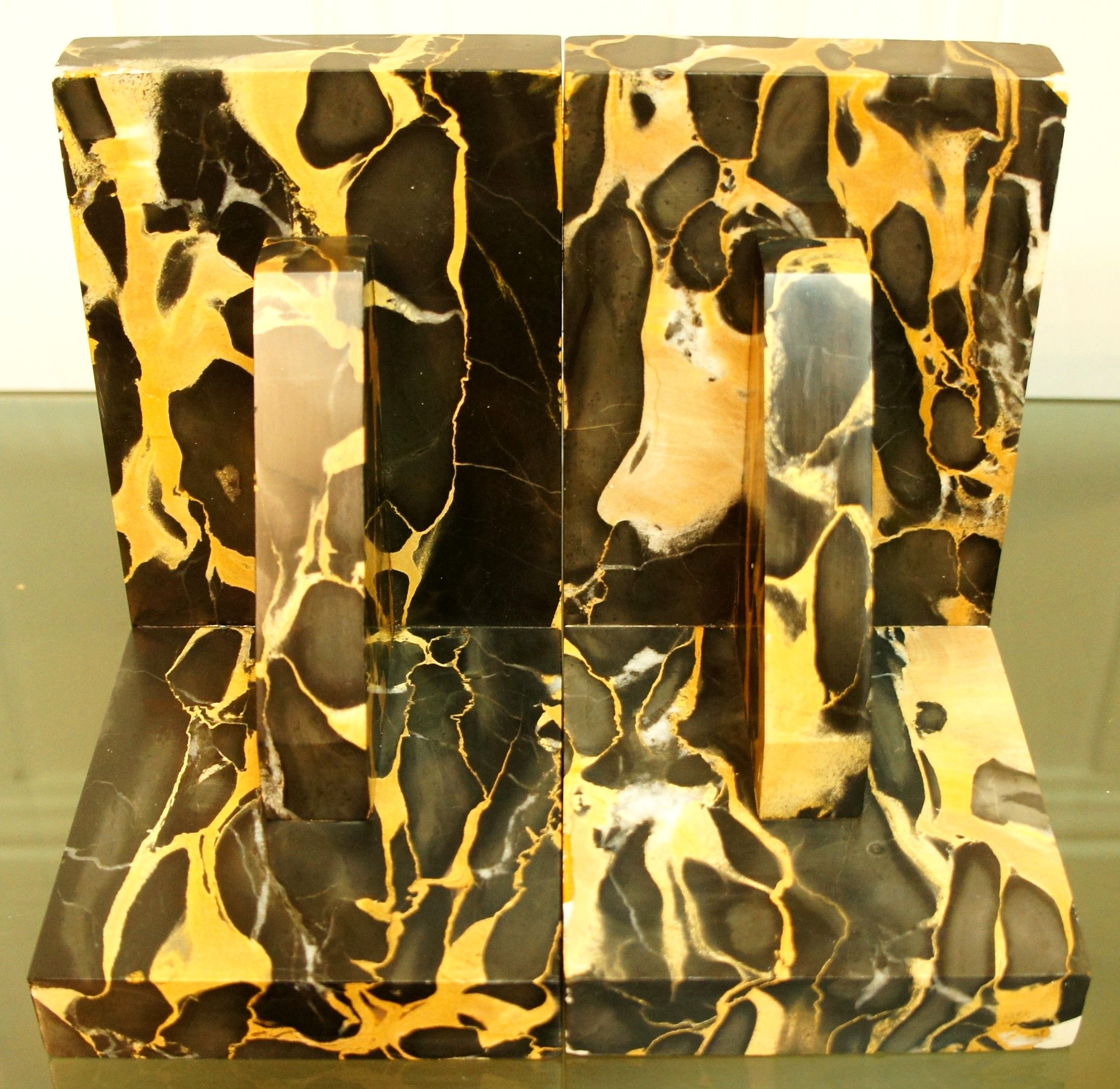 Pair of Portor marble bookends, black and golden yellow