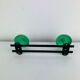 Wall-mounted coat rack with 2 green hooks from the 1950s.