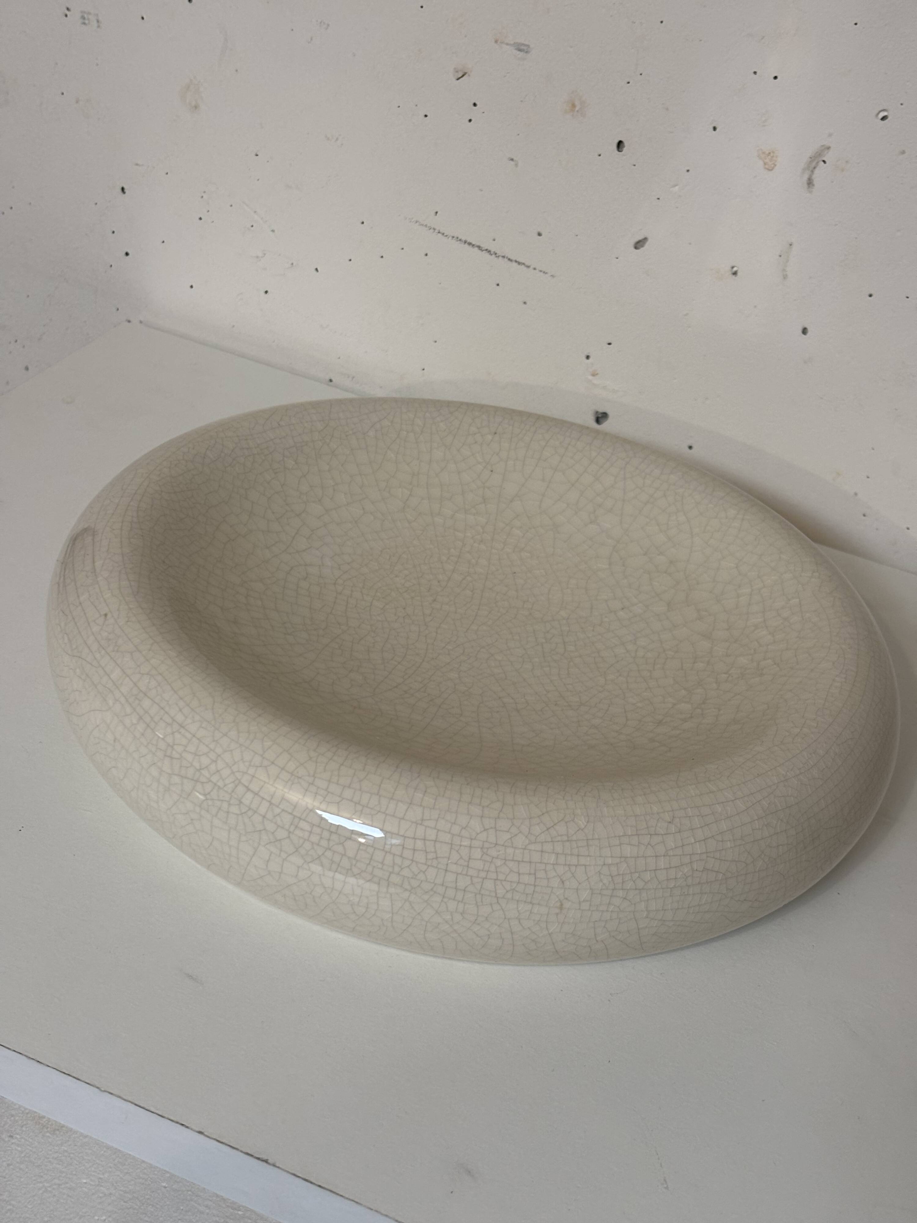 Empty pocket, cracked ceramic dish 1980