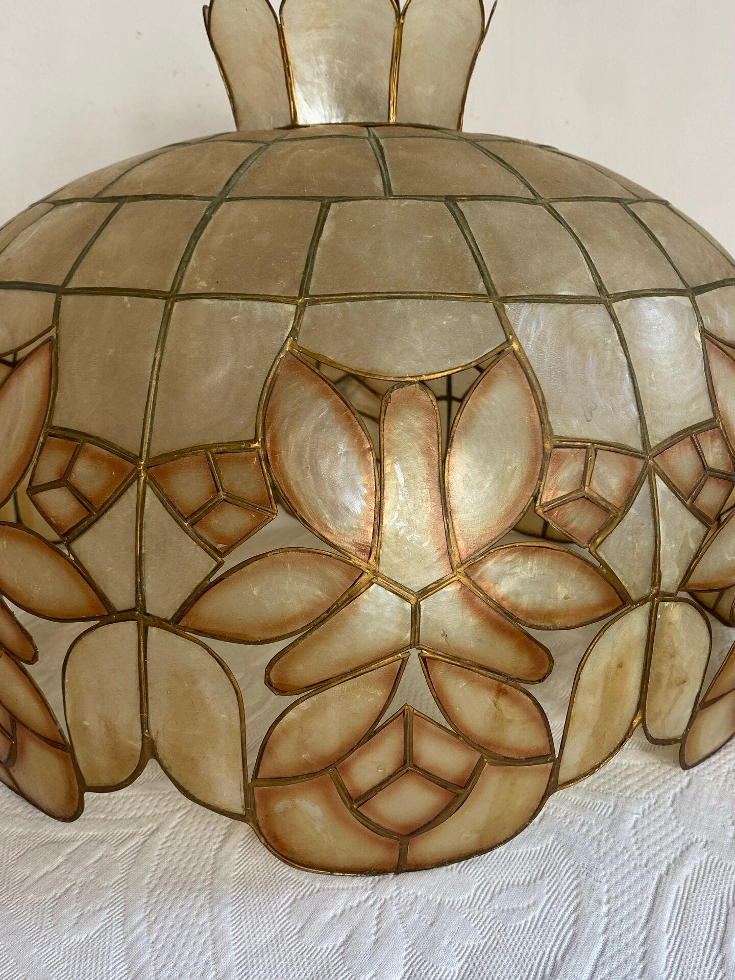 Large mother-of-pearl and brass chandelier with floral decoration.