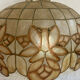 Large mother-of-pearl and brass chandelier with floral decoration.