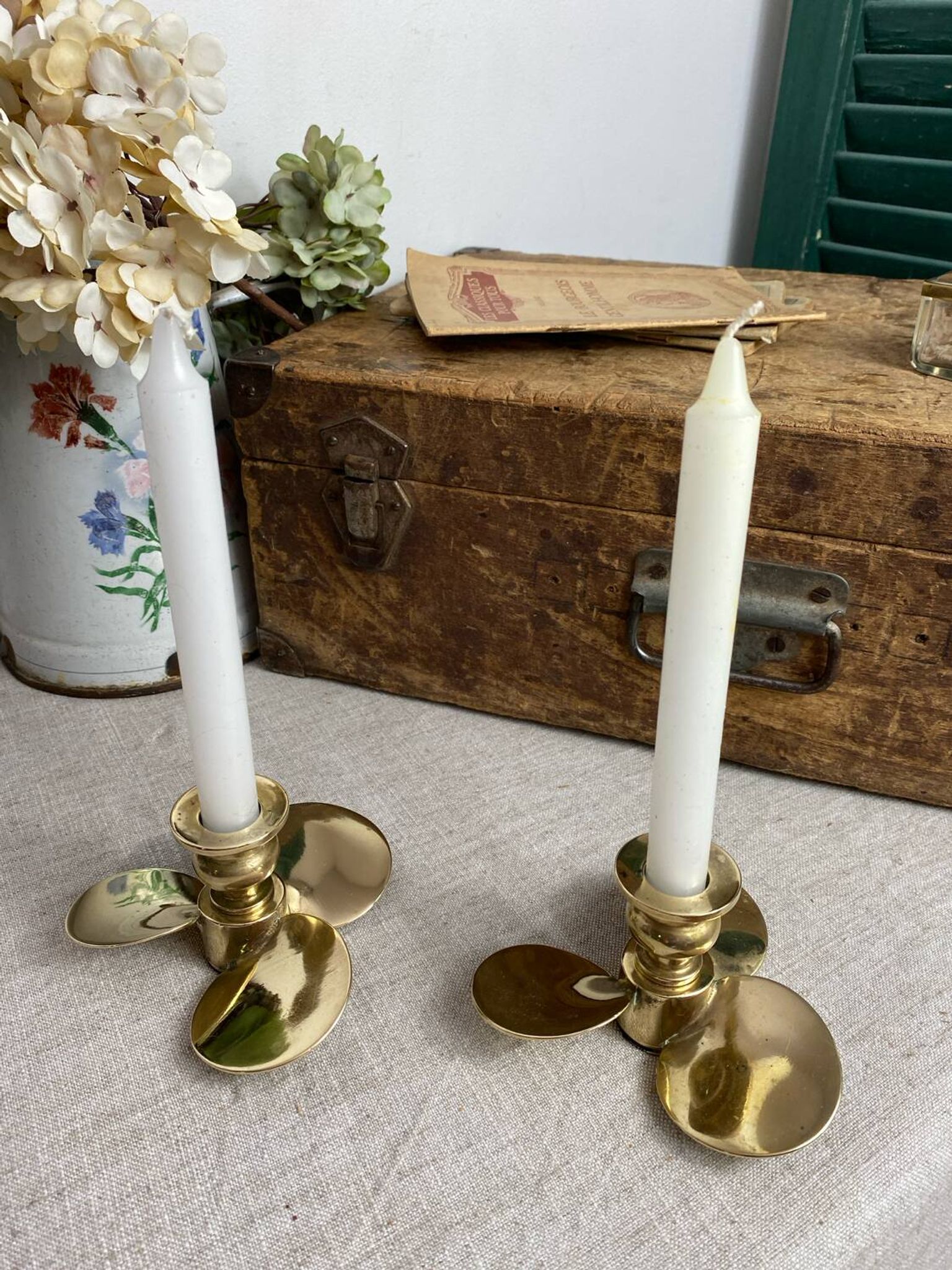 Pair of vintage brass propeller-shaped candlesticks