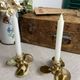 Pair of vintage brass propeller-shaped candlesticks