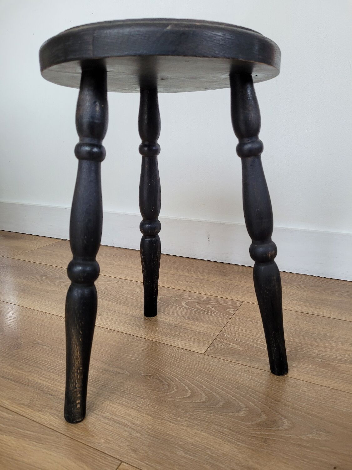 Black wooden tripod stool