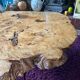 Tripod coffee table in natural solid elm magnifying glass