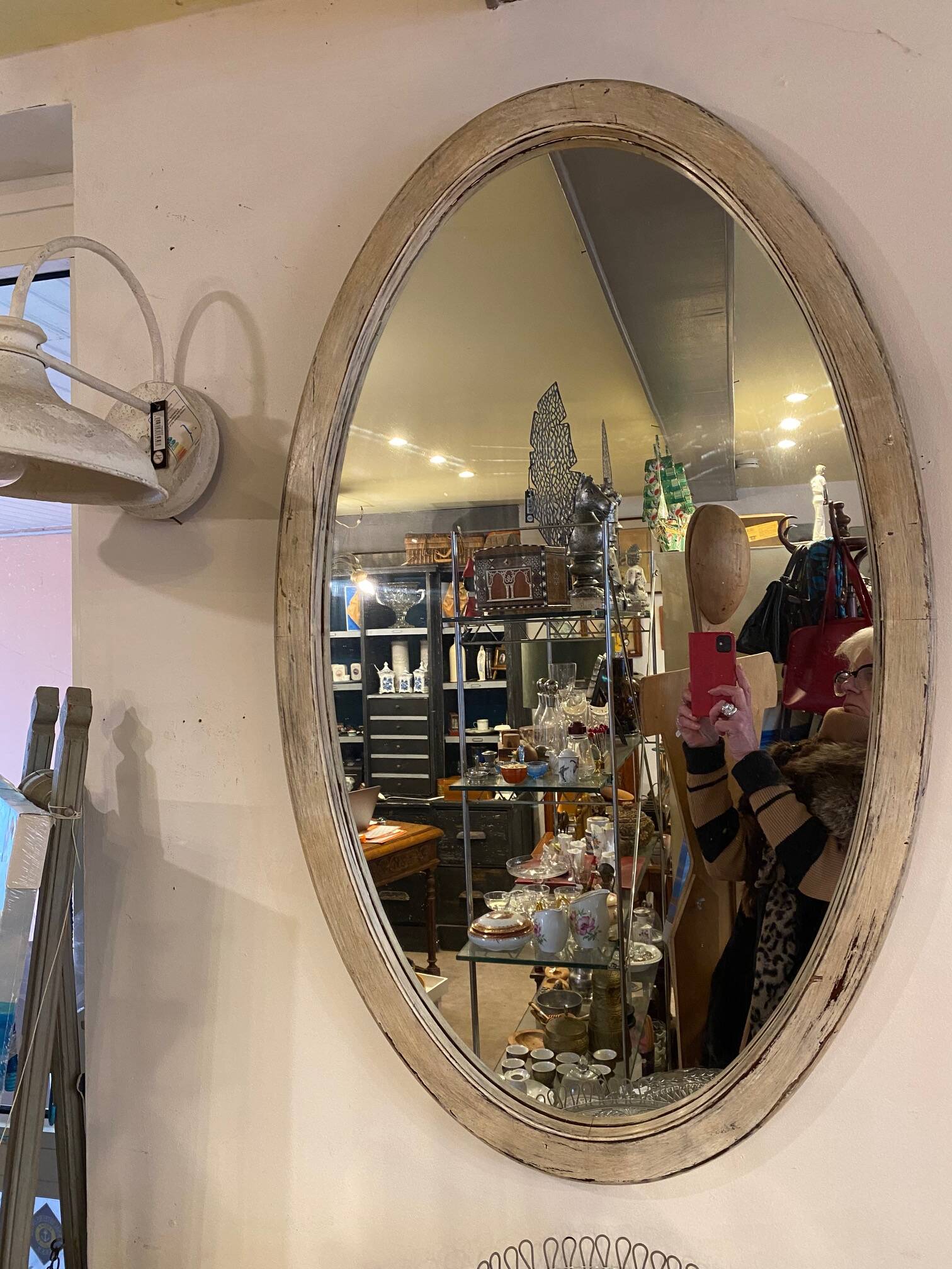 Large old oval mirror with beige patina wooden frame early 20th century