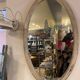 Large old oval mirror with beige patina wooden frame early 20th century