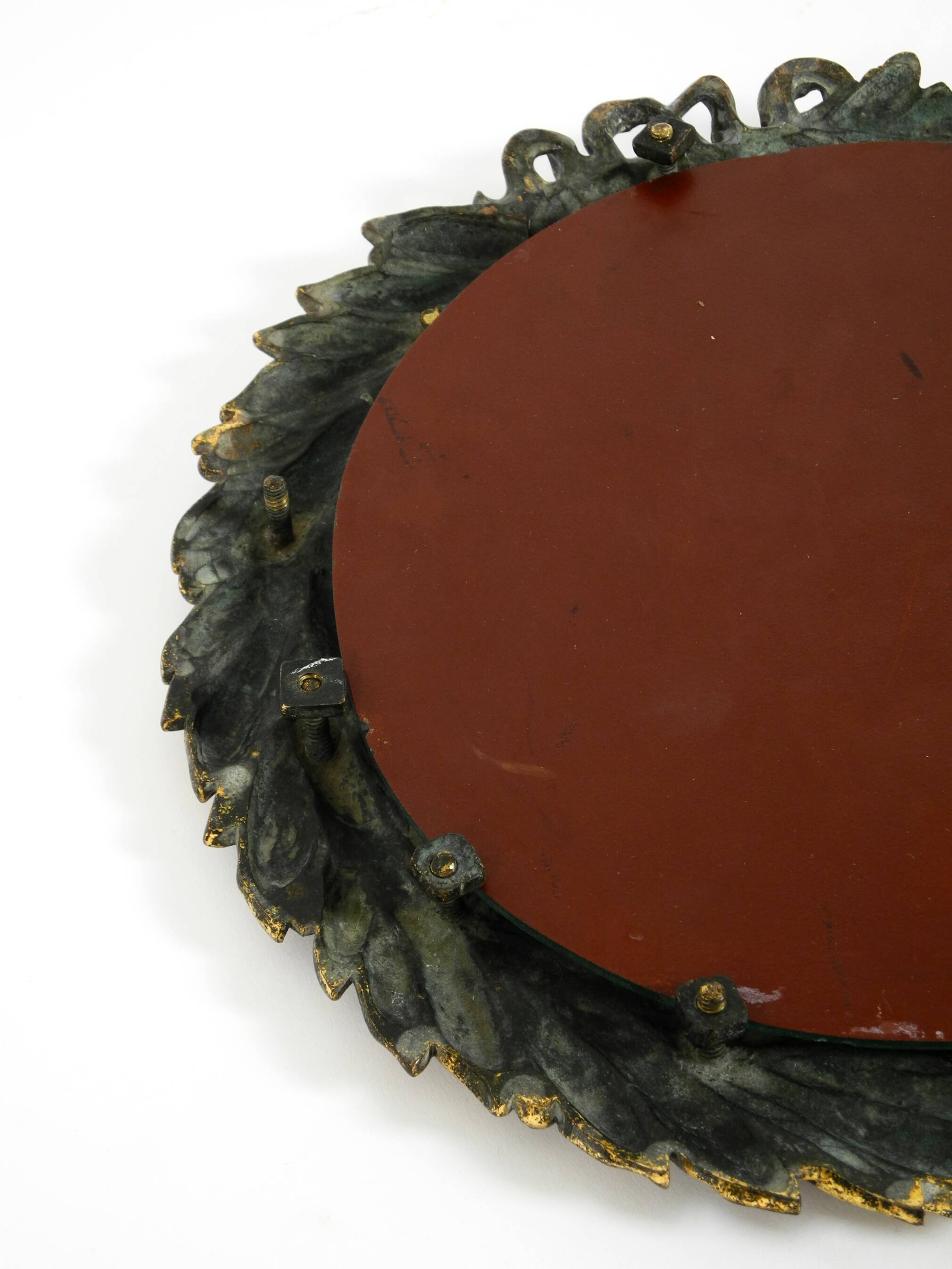 Beautiful small French mid-century wall mirror with an ornate brass frame