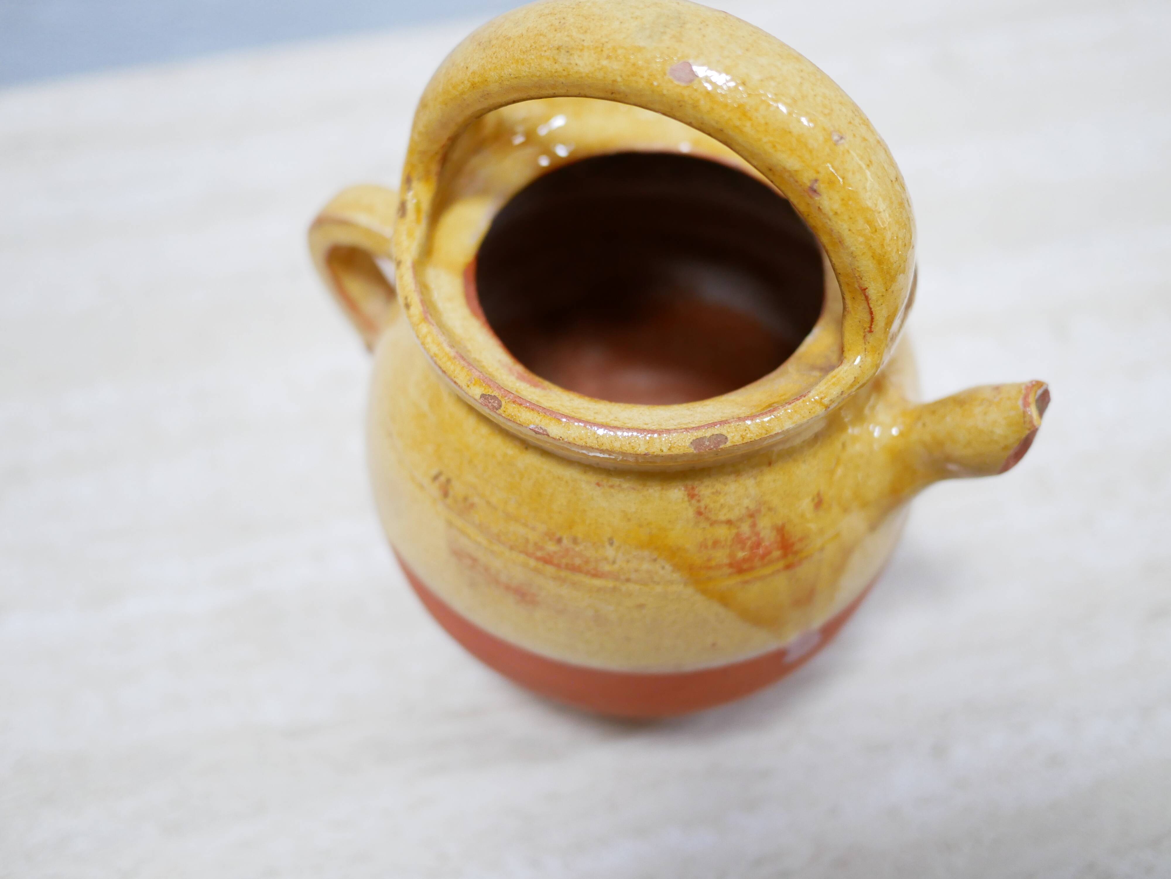 Old gargoulette pot in glazed terracotta