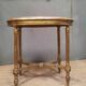 Oval coffee table in gilded wood in the Louis XVI style.