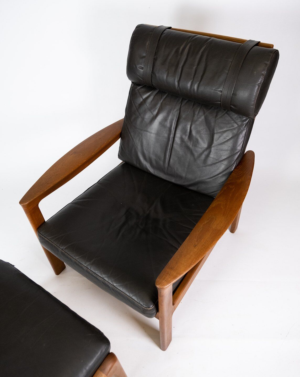 Easy chair with stool in teak upholstered with black leather design Arne Wahl Iversen
