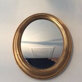 Old oval mirror in gilded wood