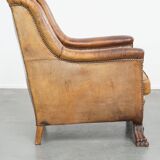 Characteristic antique sheepskin leather armchair with beautiful details and a unique design