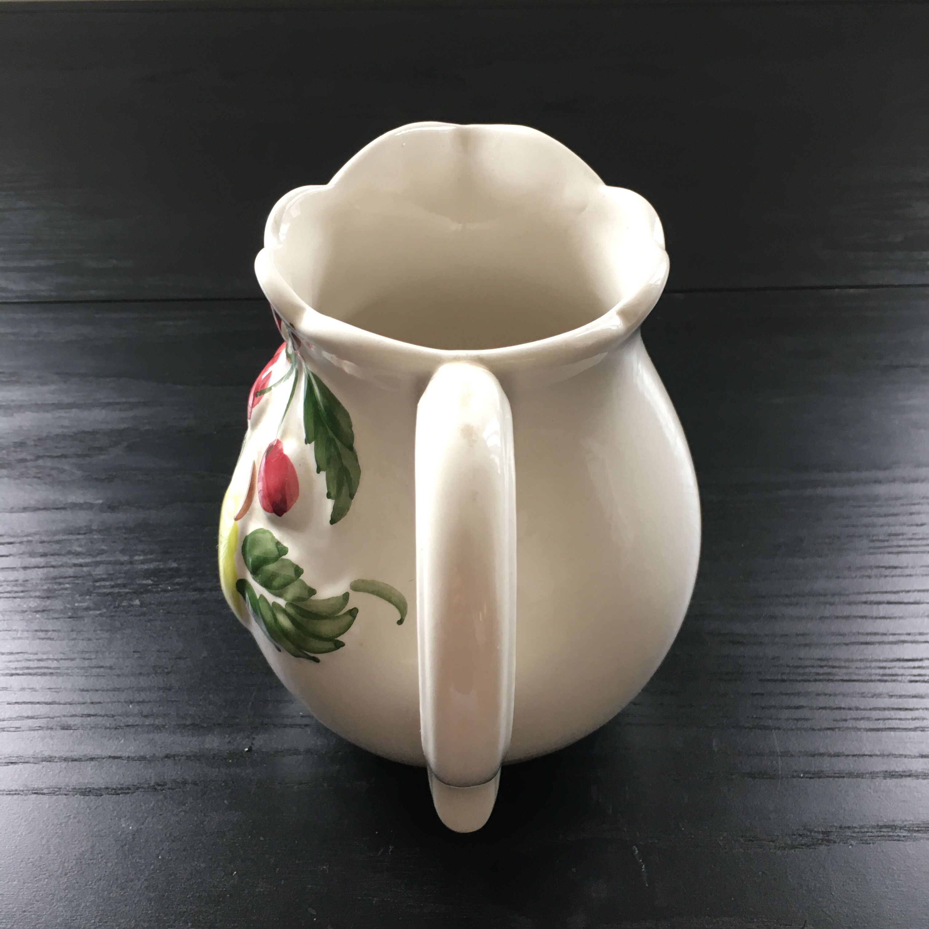 Fruit-decorated pitcher in slipware