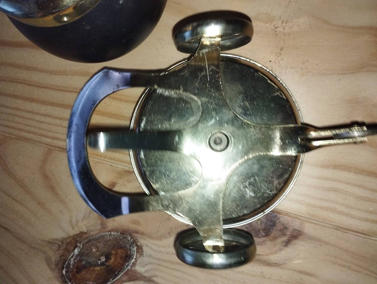 Original vintage ashtray on a small wheeled stand.