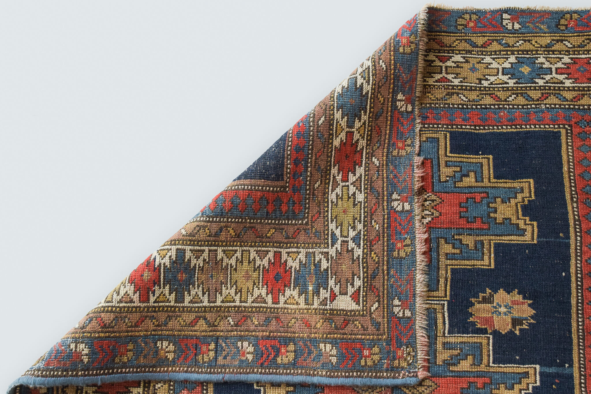 Handwoven blue ground persian rug with bird-like figures