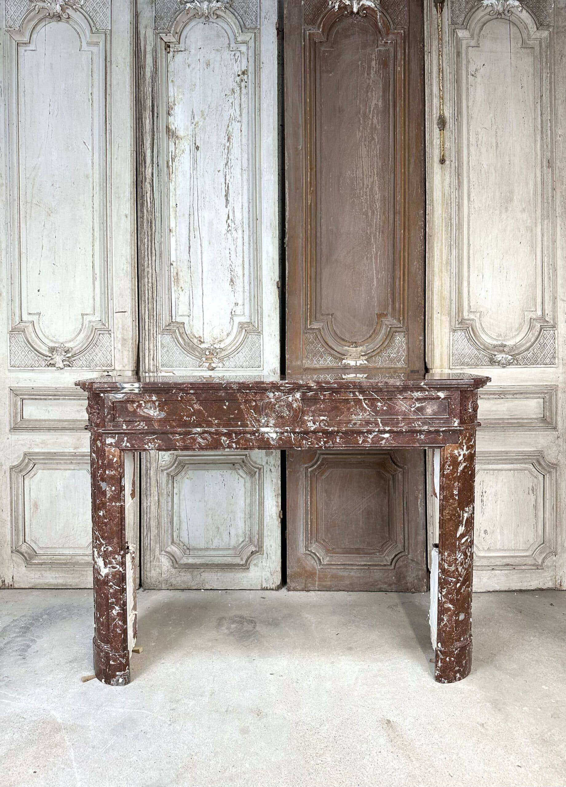 Red marble fireplace in the Louis XVI style, late 19th century
