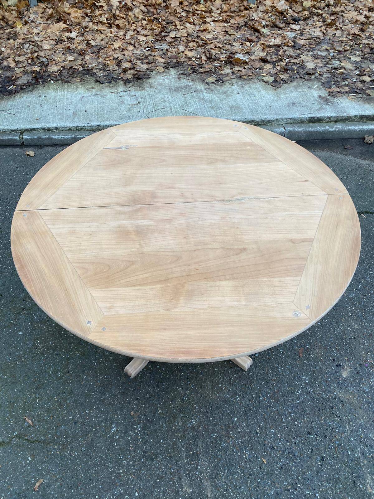 Round extendable dining table with a central pedestal base, renovated in raw wood, 150cm
