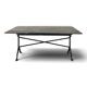 Garden table with a cast iron base and a green painted wooden top.