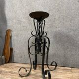 Wrought iron candlestick on four-legged base circa 1900-1930