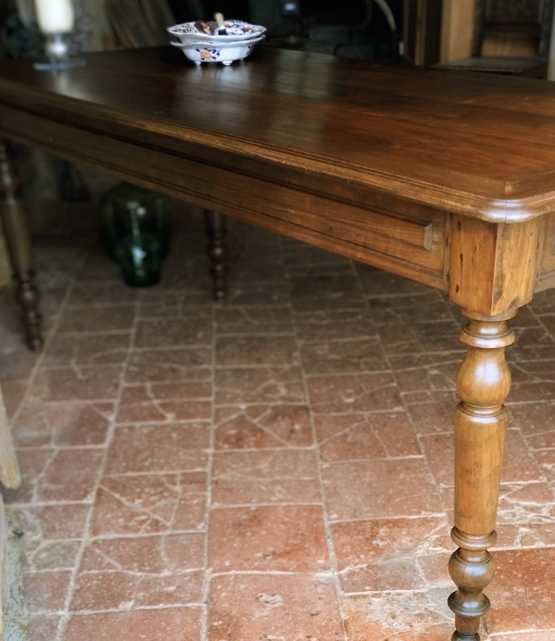 Old French farmhouse table in walnut with turned legs.