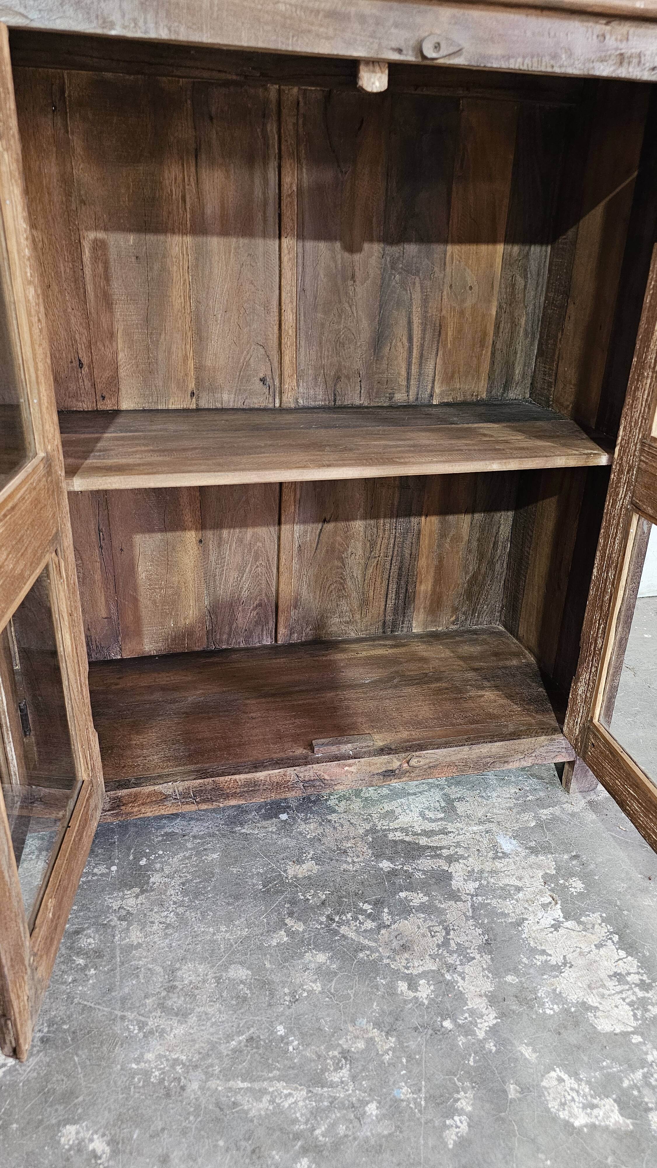 Antique glass-fronted buffet in Burmese teak