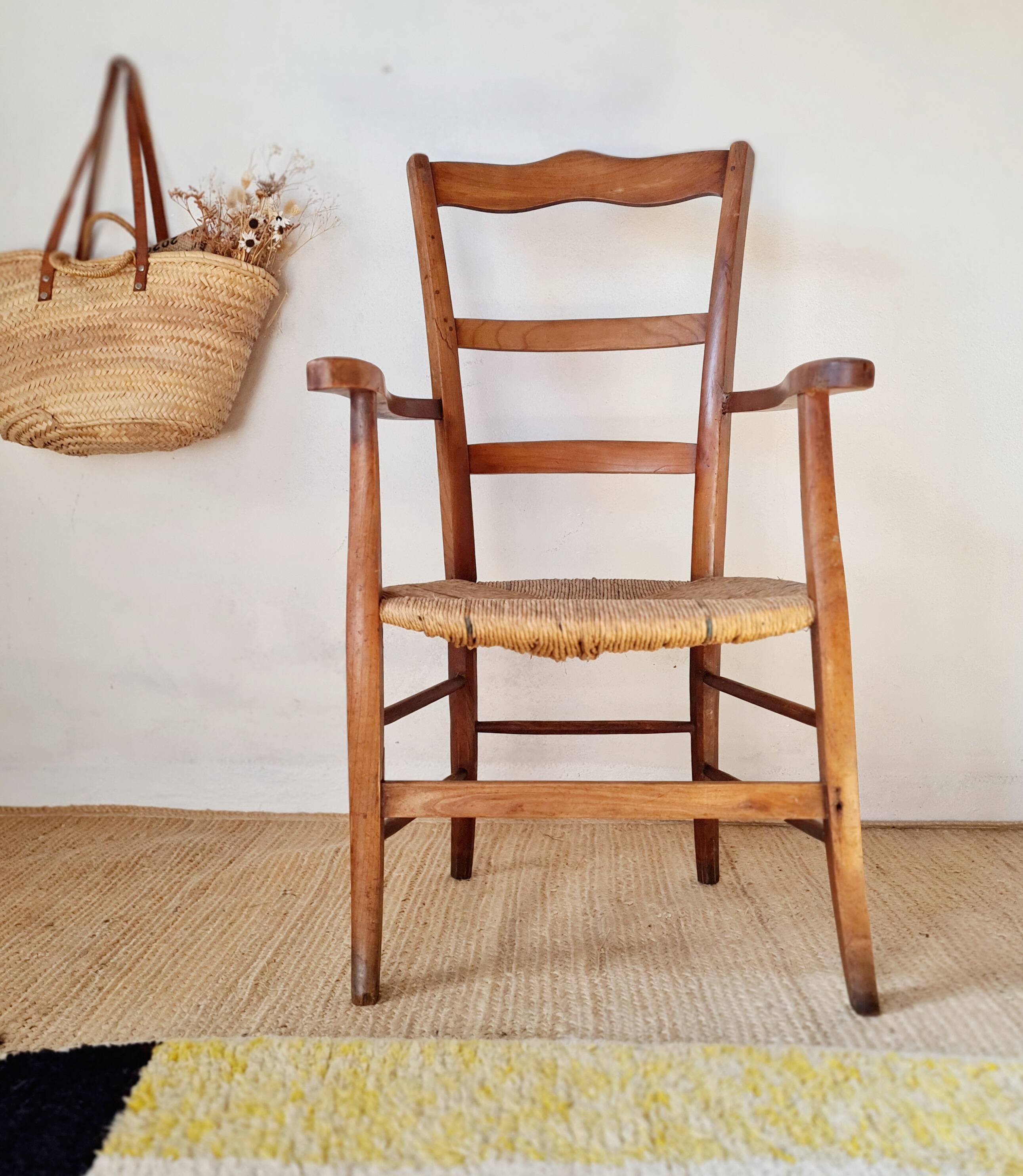 Antique campaign chair in wood and straw