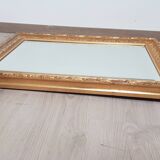 Mirror in gilded stucco wood and beveled glass