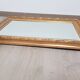 Miroir en bois stuc doré et verre biseauté