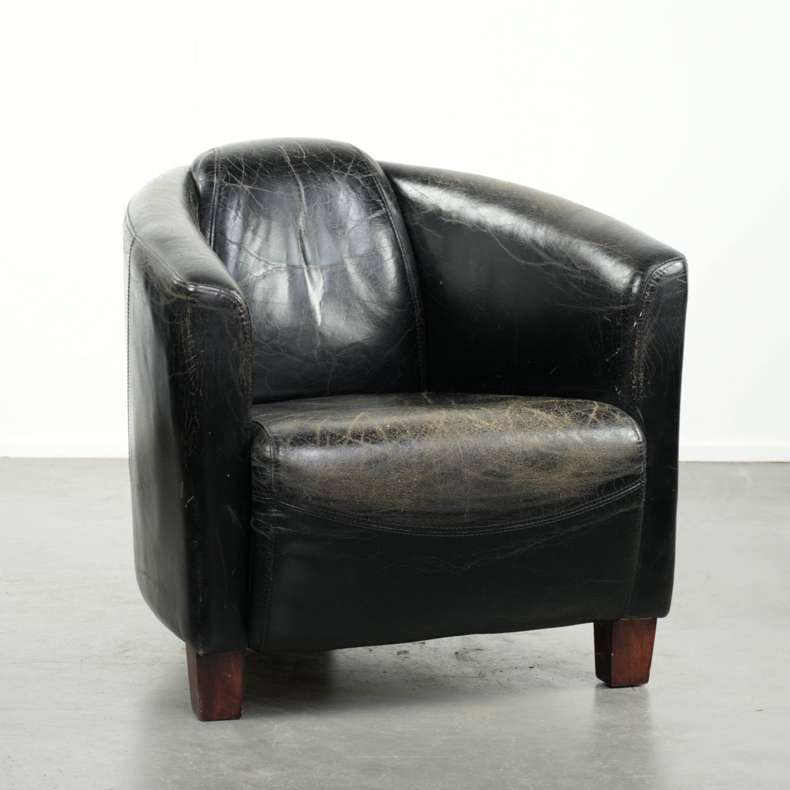 Black vintage cowhide aviator design armchair with characterful appearance