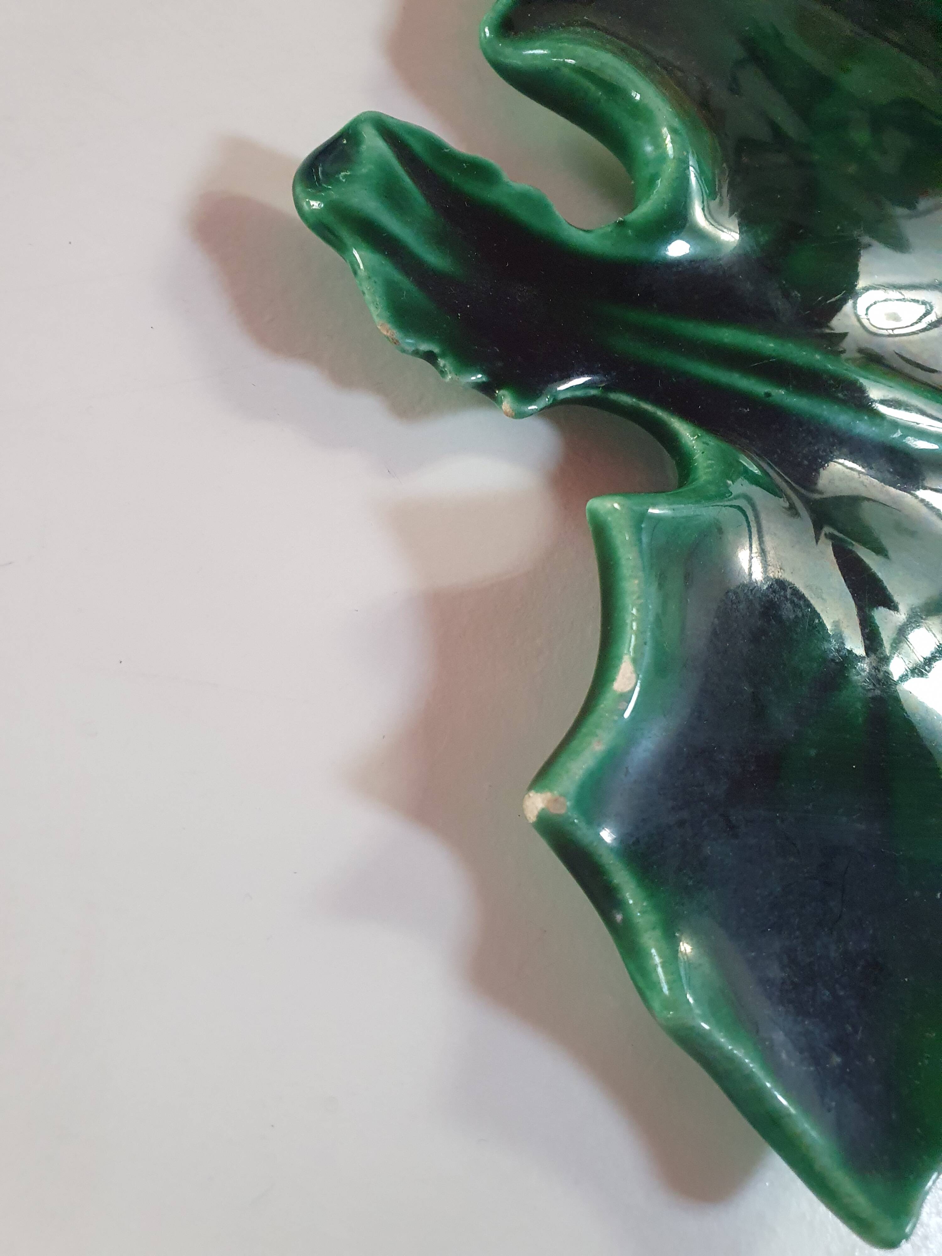 empty green ceramic pocket cup, small chips on the edges, signed