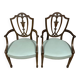According to George Hepplewhite: pair of 19th century mahogany office armchairs