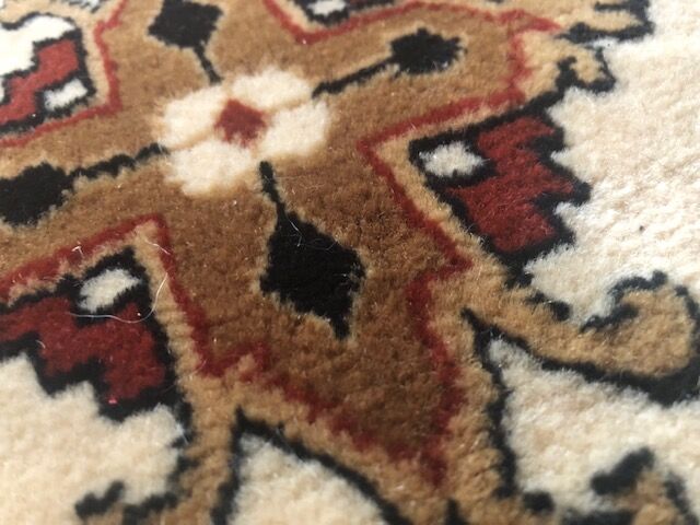 Wool carpet with oriental decoration on a brown background