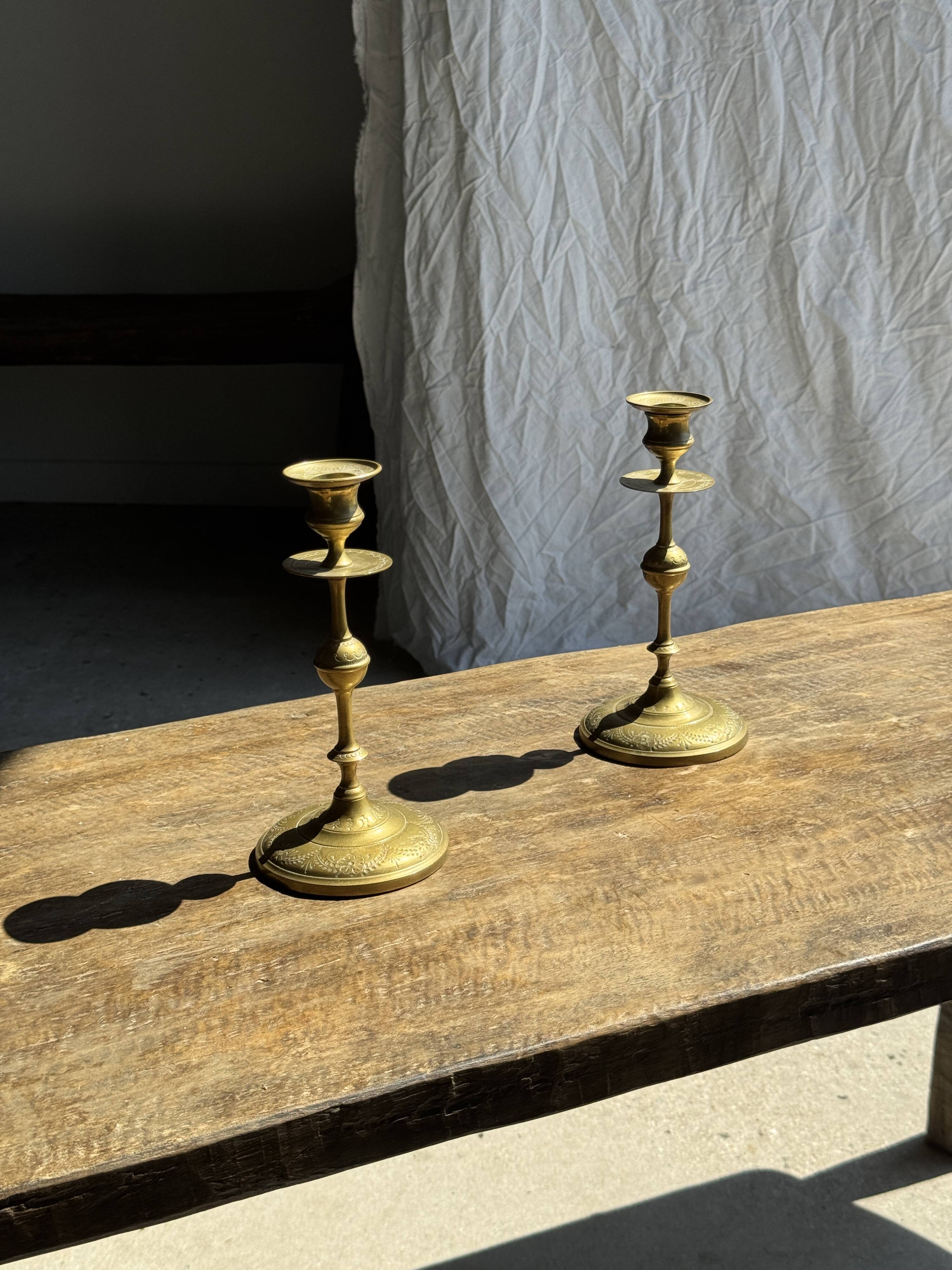 Pair of gilded candlesticks with engraved flower garland motifs H22