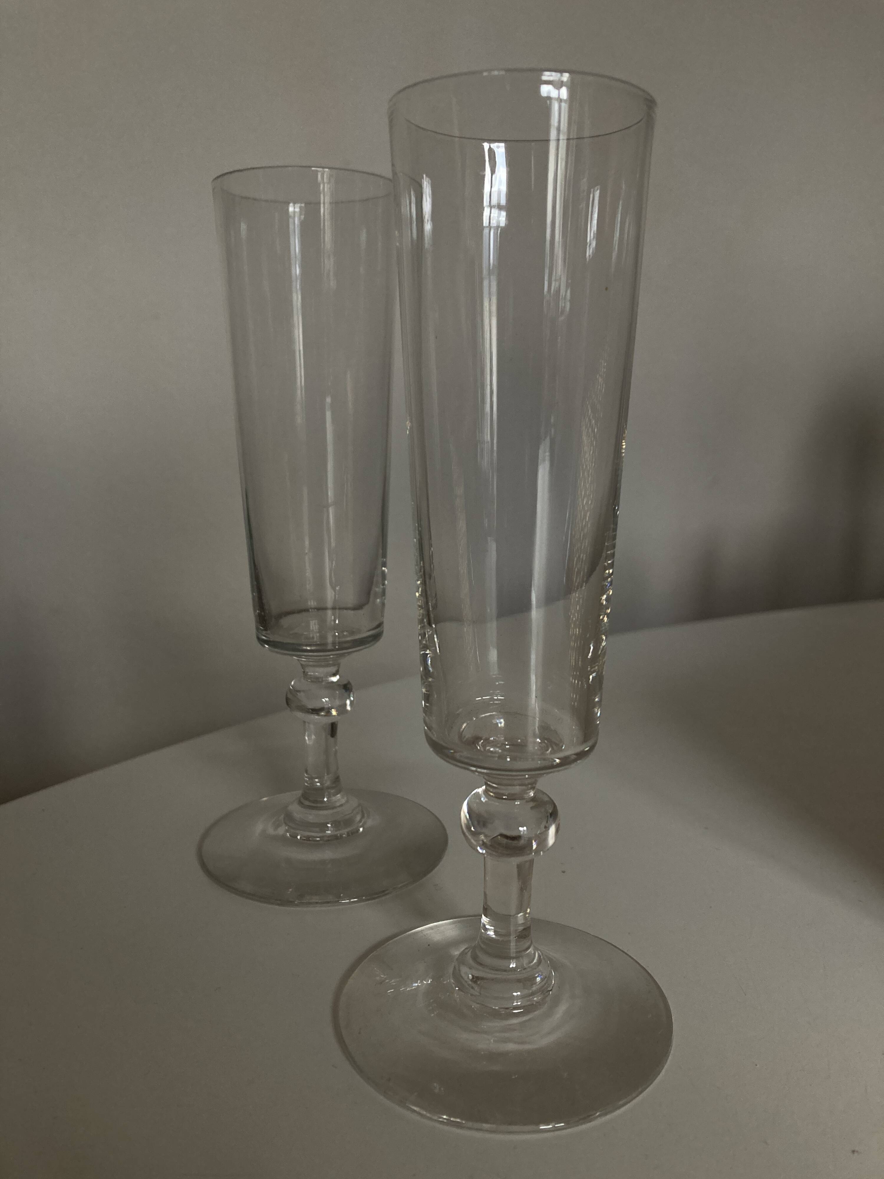Pair of crystal champagne flutes with a button foot, 1960.