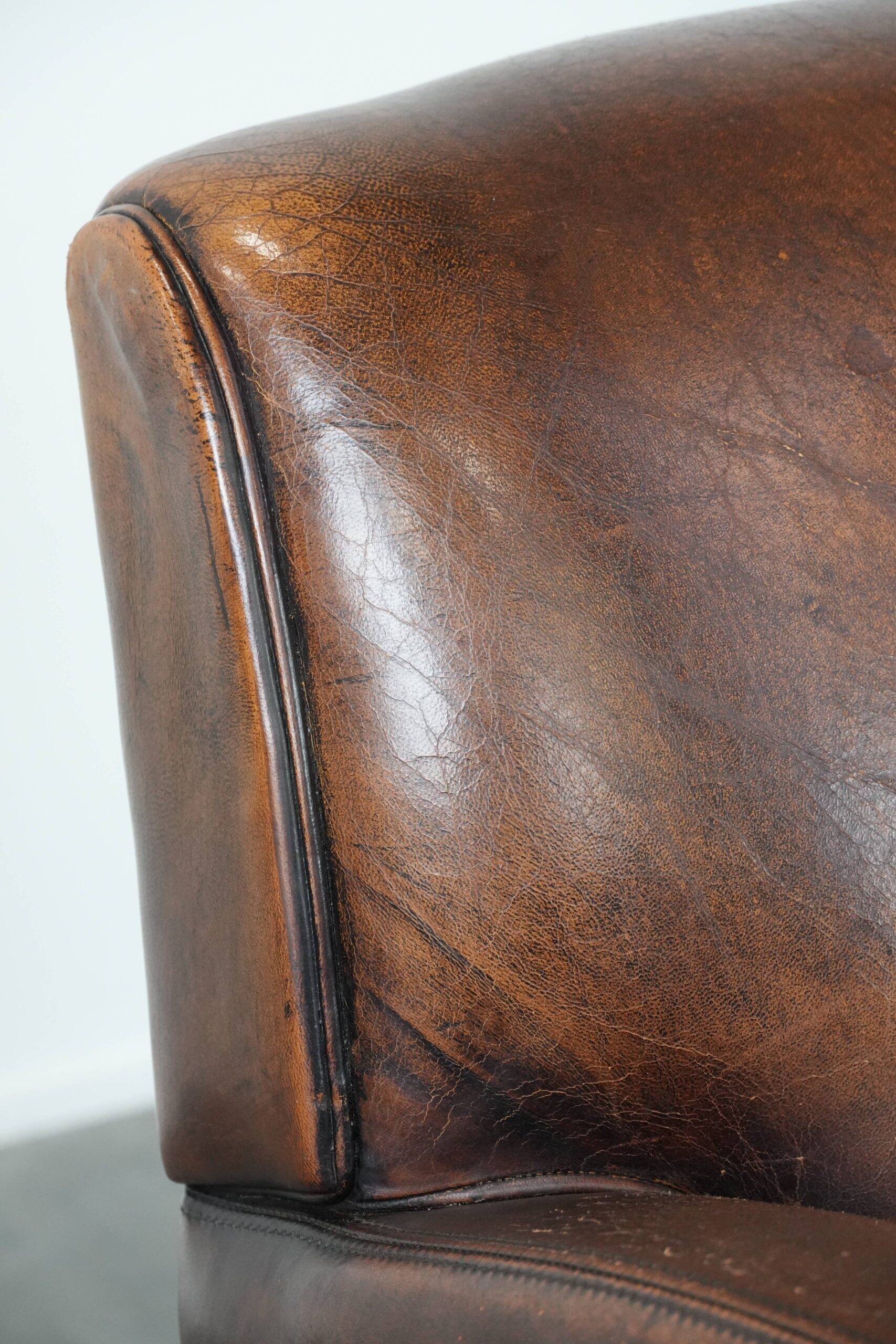 Characterful vintage sheepskin leather armchair with beautiful colours