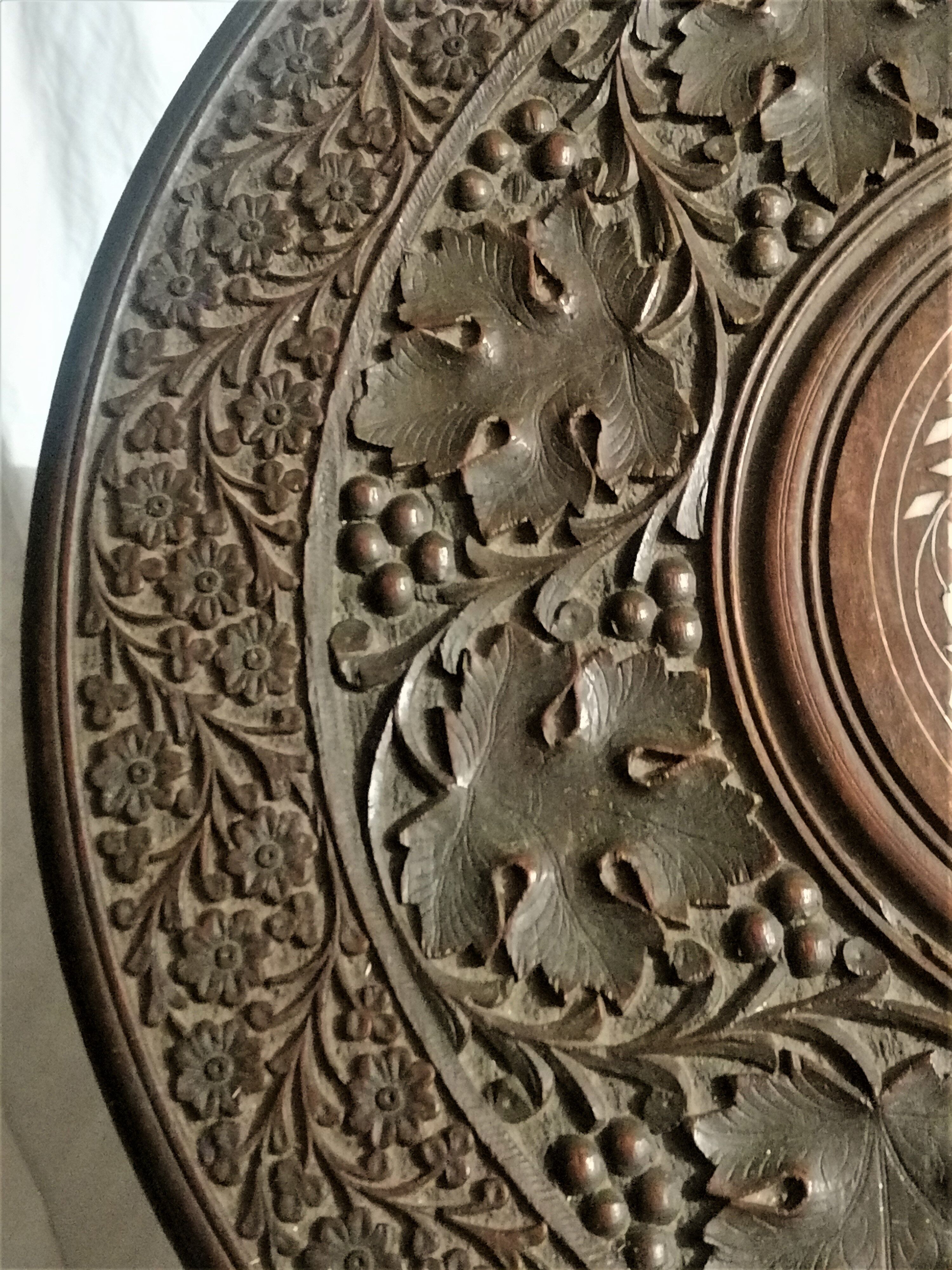 Ancient oriental pedestal table in carved wood