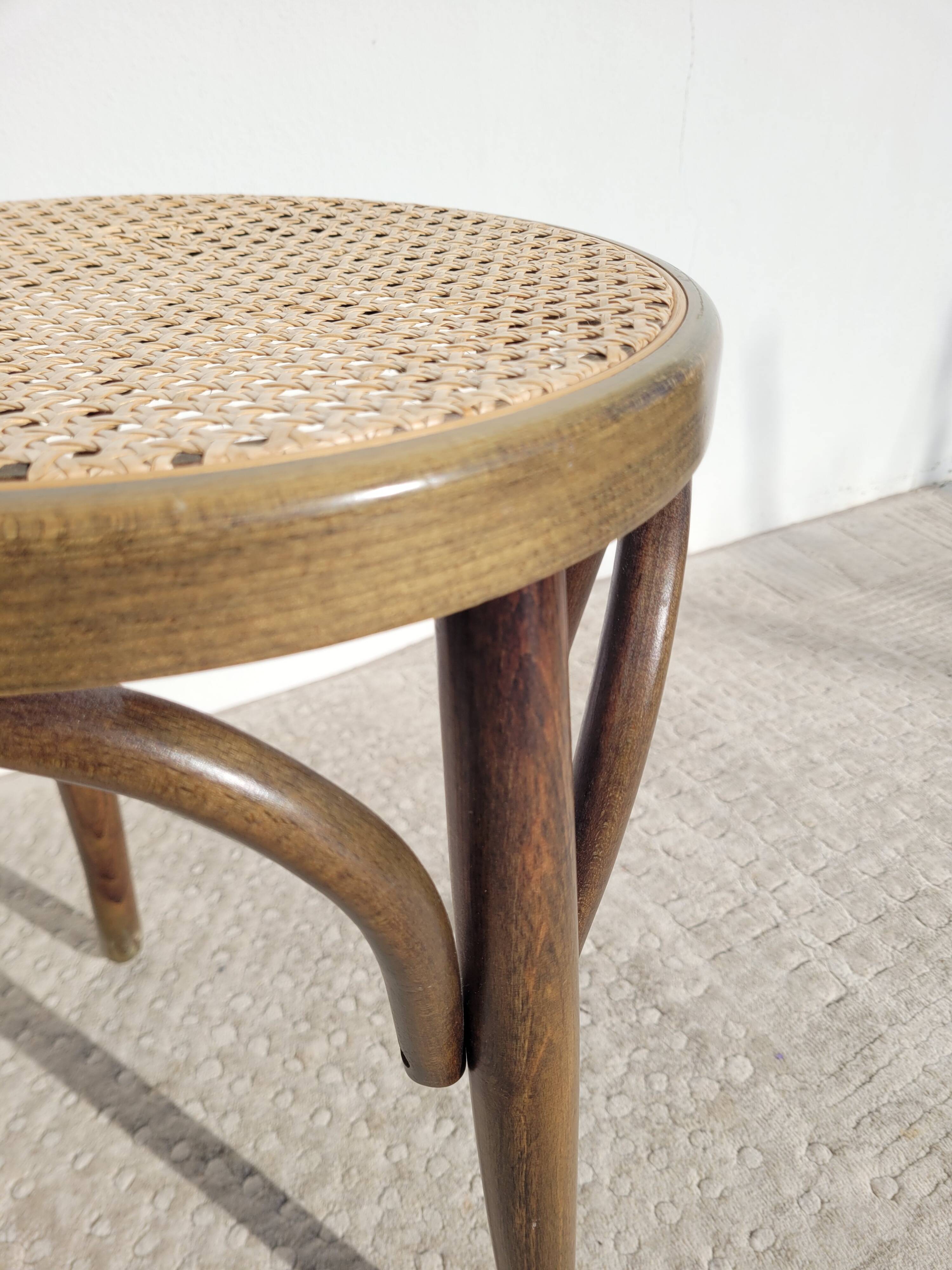 Low stool in cane and curved wood
