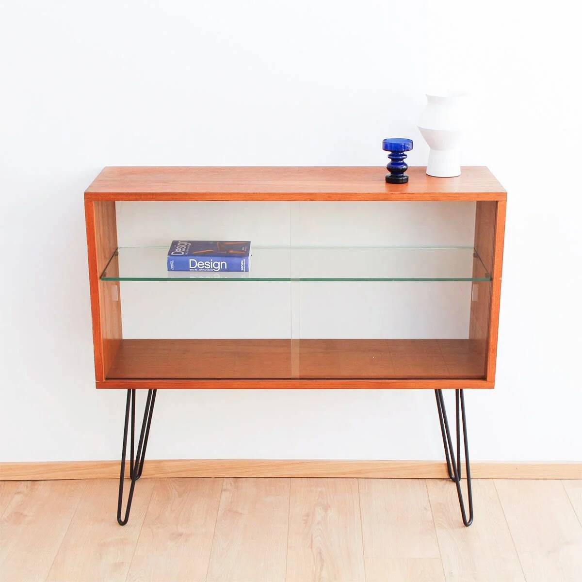 Teak display cabinet with black hairpin legs.