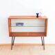 Teak display cabinet with black hairpin legs.