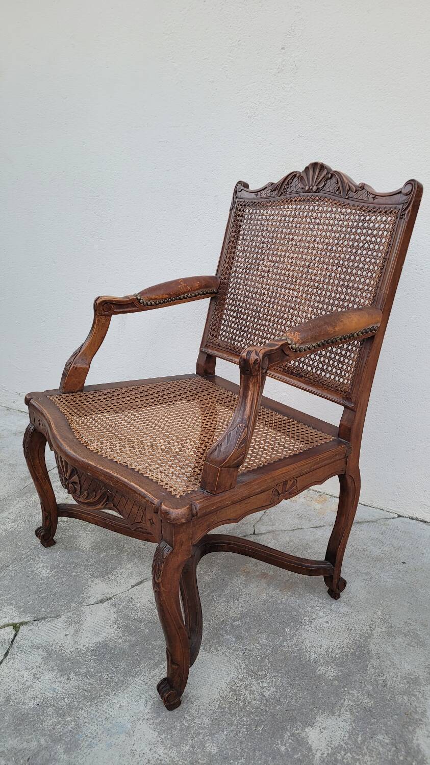Louis XV Regency cane armchair leather armrests decorated with shell