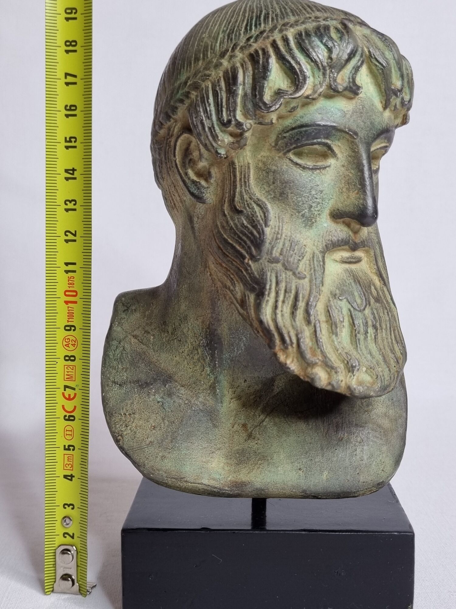 Bust of Poseidon in patinated plaster on wooden base