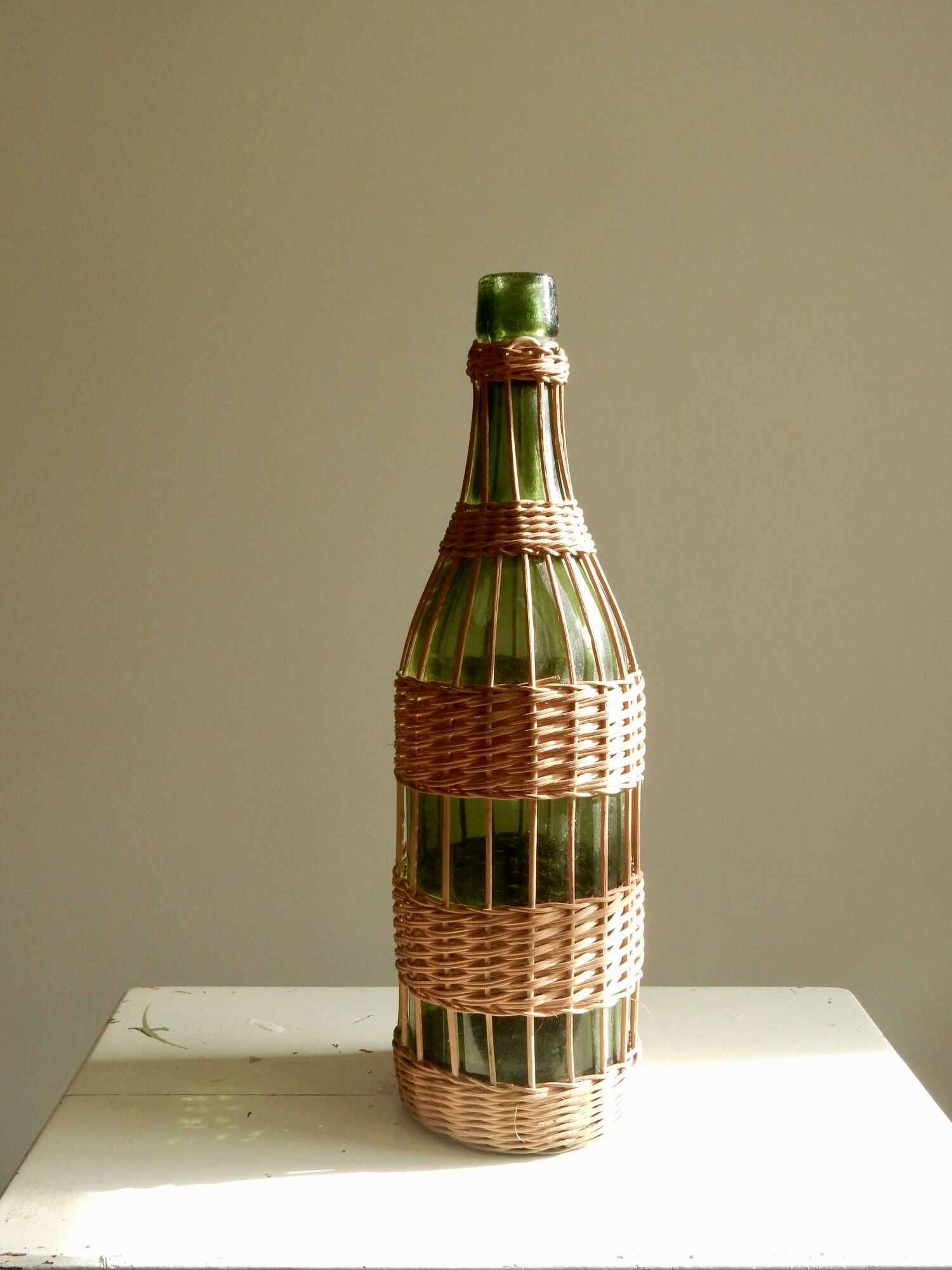 Glass bottle covered with wicker, France of the 60