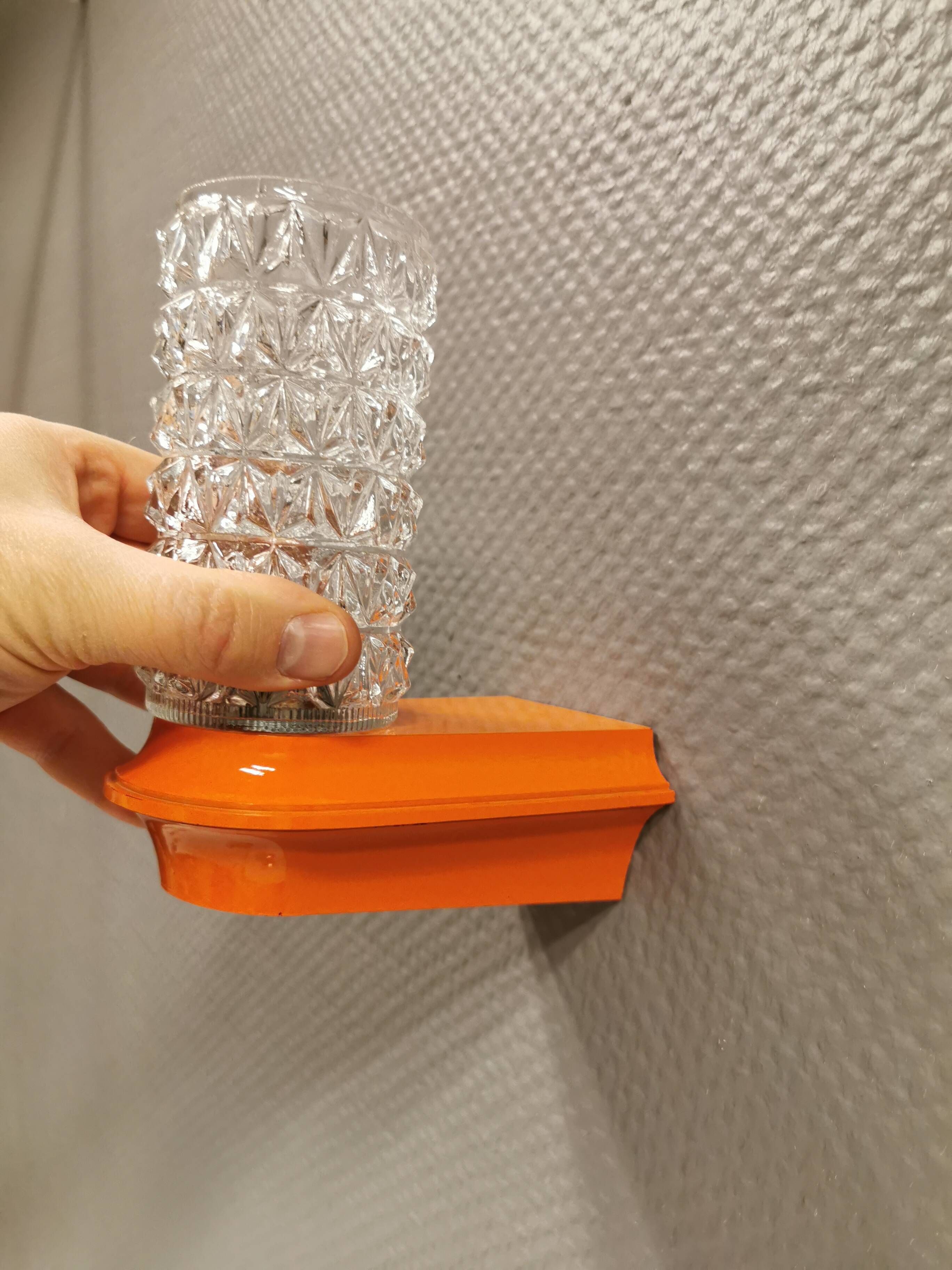 Bathroom lamps in a nice orange colour with a crystal glass shade and a base of hard thin plastic