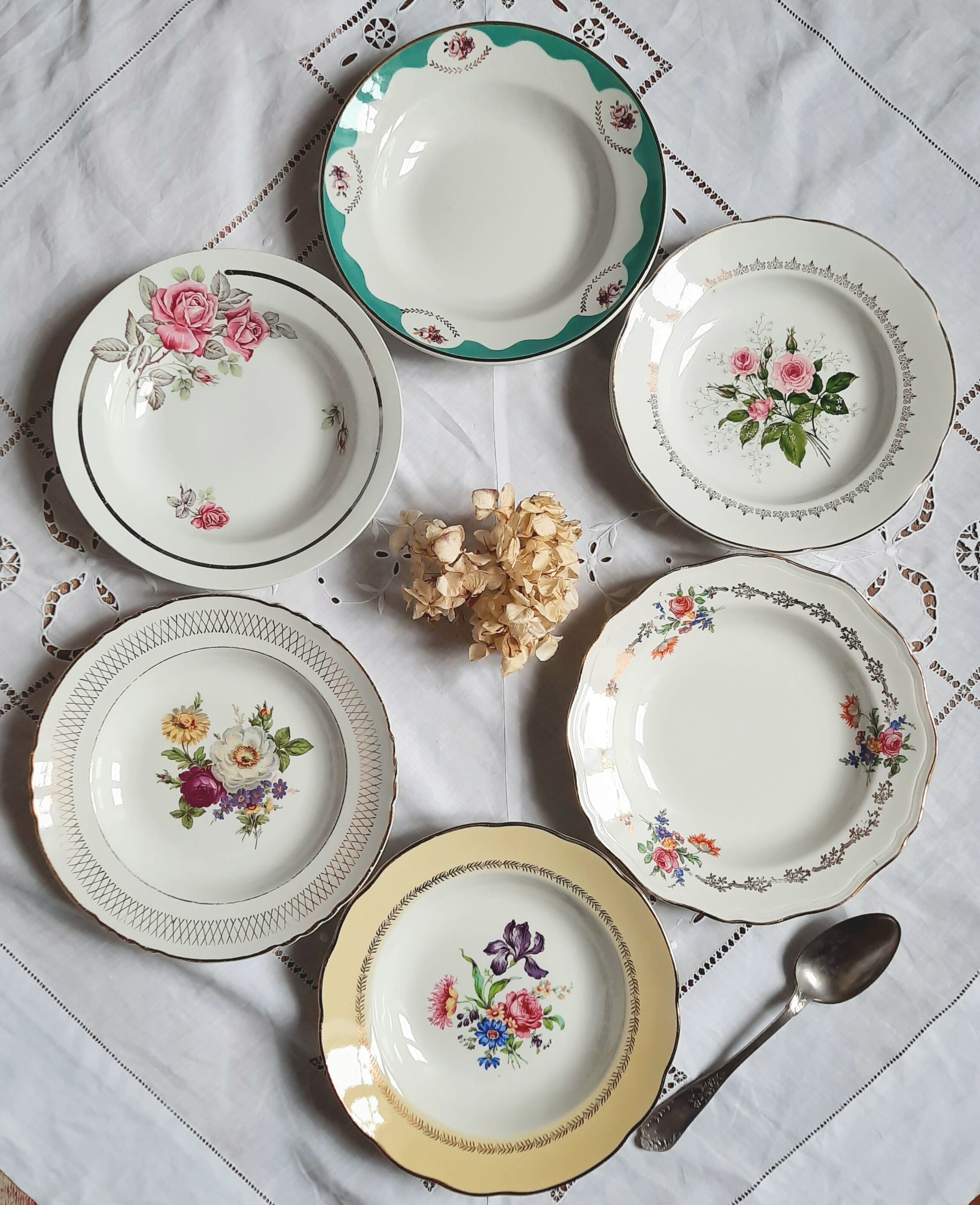 Old hollow plates mismatched in earthenware with gilded edges