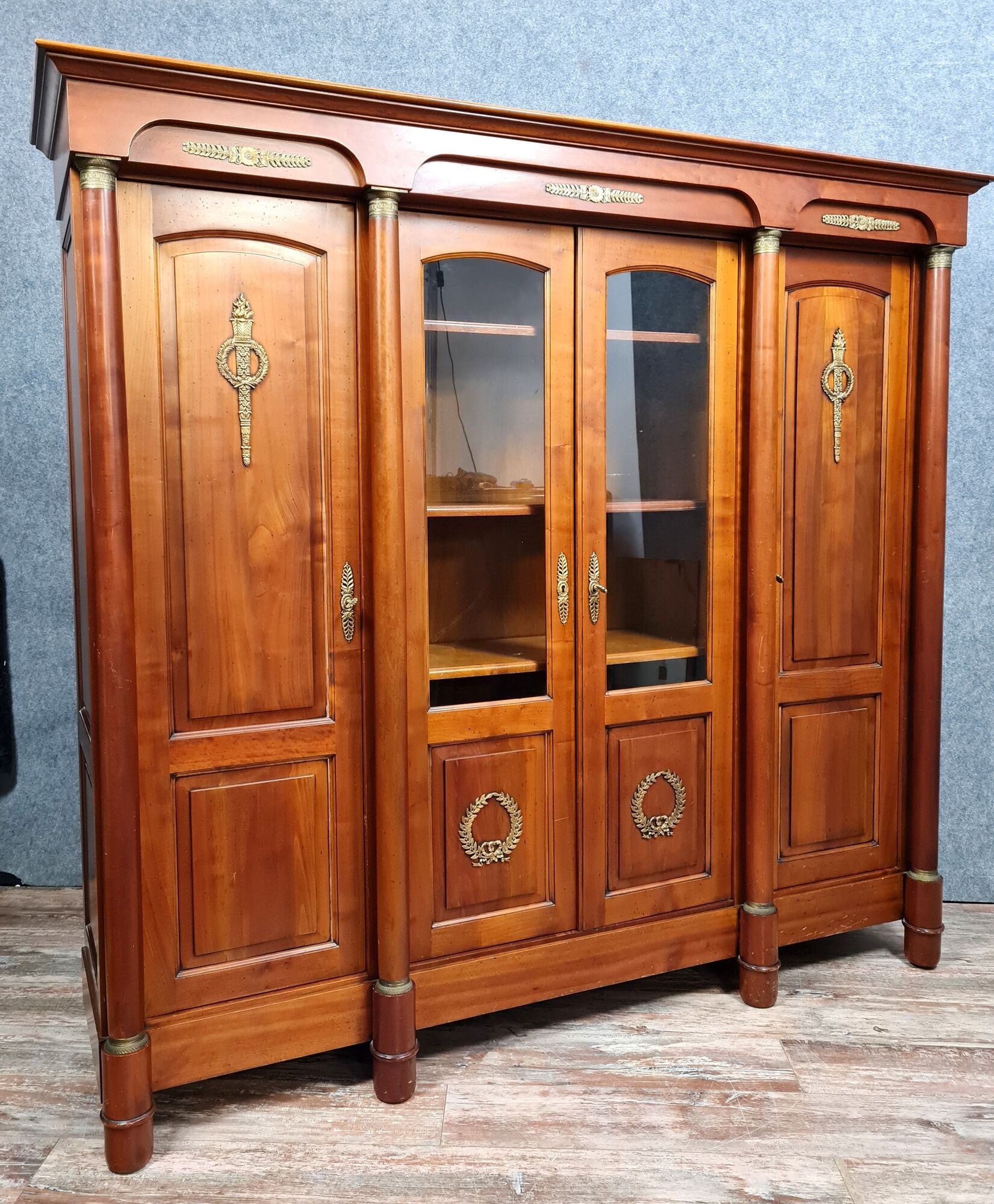 Empire library in cherry tree with blonde patina and gilded bronze around 1950