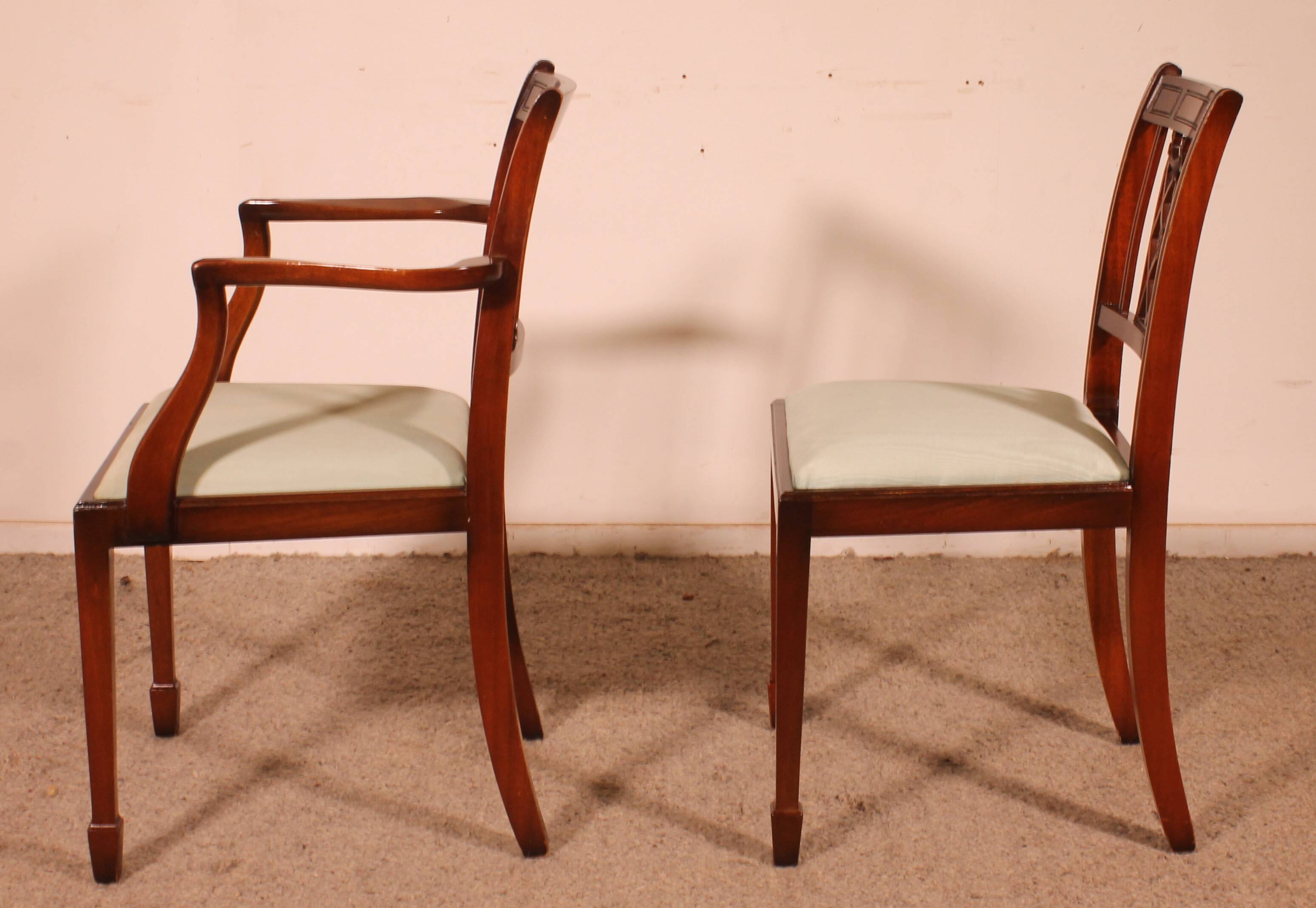 Set of 10 chairs and two mahogany armchairs in Hepplewhite style.